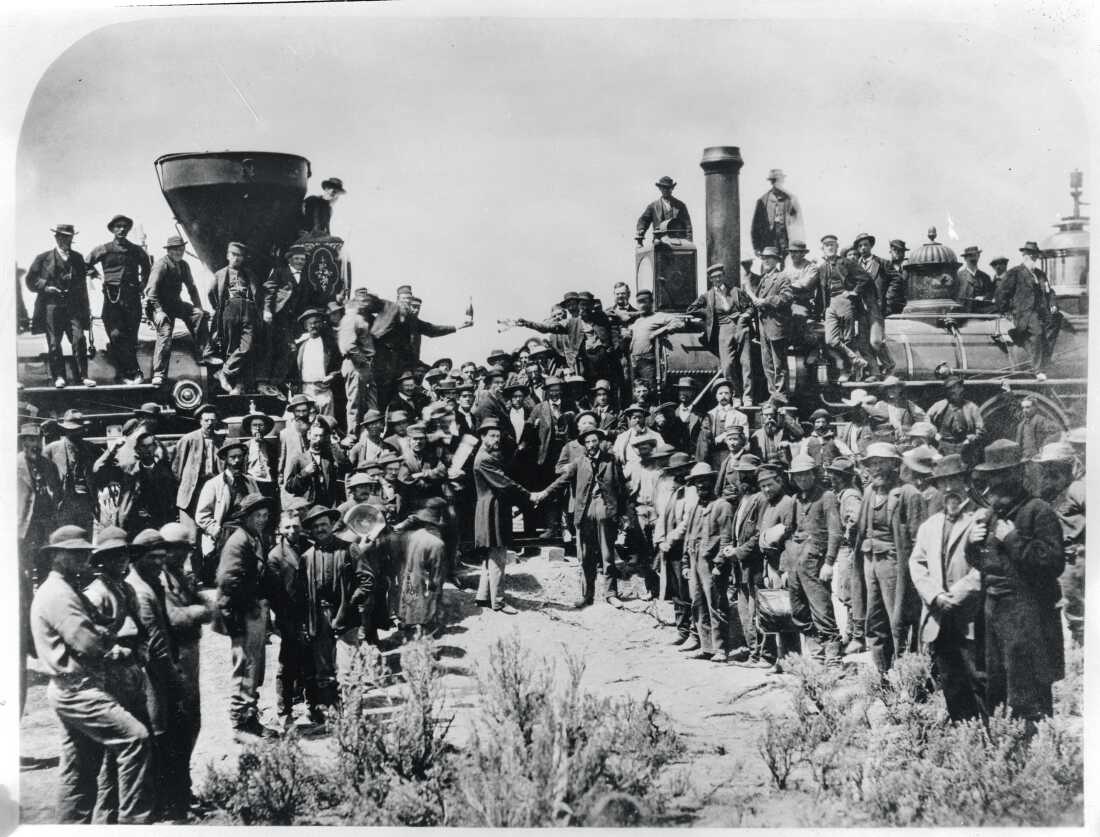 Railroad workers celebrate at the driving of the Golden Spike Ceremony in Utah on May 10, 1869 signifying completion of the first transcontinental railroad route created by joining the Central Pacific and Union Pacific Railroads.