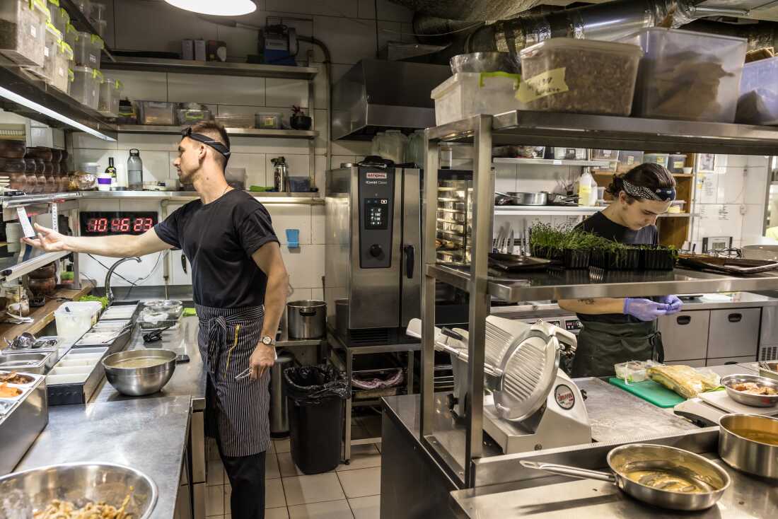 Kitchen workers prepared meals in Yevhen Klopotenko's restaurant 100 rokiv tomu vpered in Kyiv, Ukraine, on Aug. 14.