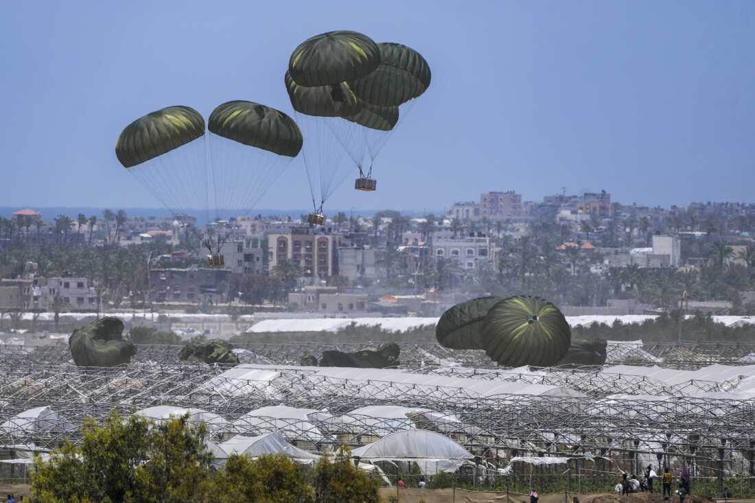 An aircraft airdrops humanitarian aid over Khan Younis, Gaza Strip, May 30.
