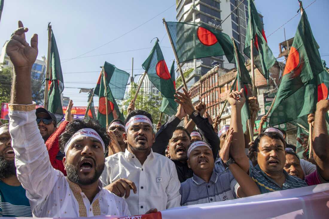 Bangladesh Nationalist Party leaders and supporters protest in Dhaka on November 8. Many are waving Bangladesh's green and red flag.