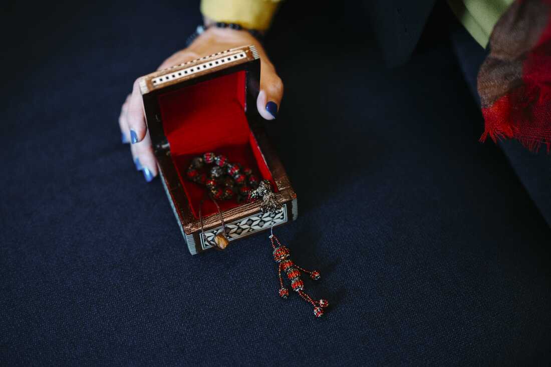 Nazan Rashidi holds a trinket that was made by her now husband more than 10 years ago in a detention center.