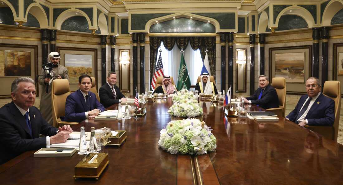 Russian and U.S. officials, including Steve Witkoff, sit at a table in Saudi Arabia.