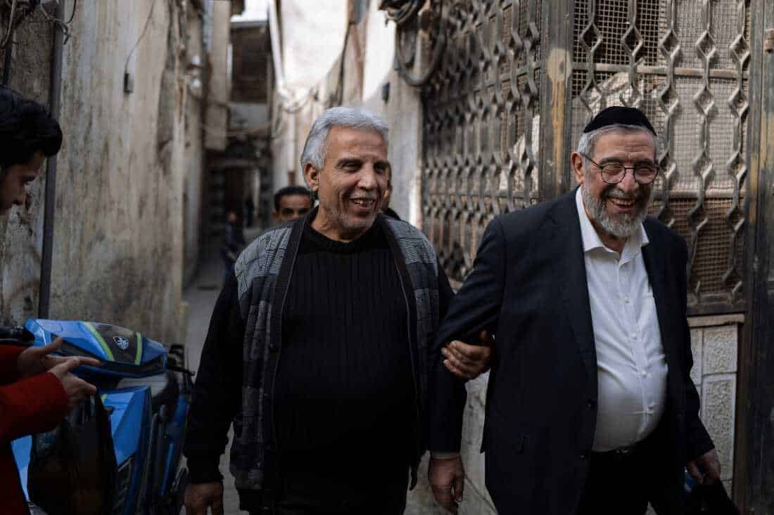 DAMASCUS, Syria, 02/19/25 Rabbi Yousif Hamra reconnects with an old neighbour from the Jewish Quarter which he left 33 years ago. Ayman Oghanna for NPR