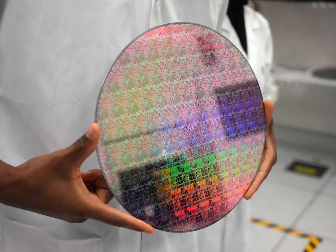 A silicon wafer with microchips etched into it. Microchips are etched using specific wavelengths of light. Better measurements of the wavelengths in ultraviolet light are required to advance chip manufacturing.