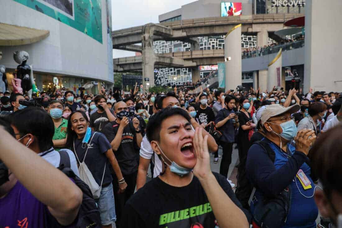 Thai protesters cheer during a pro-democracy rally at the Pathumwan Intersection on Feb. 10, 2021, in Bangkok, Thailand. Protesters descended on a shopping mall in central Bangkok to stage a "make noise" campaign.