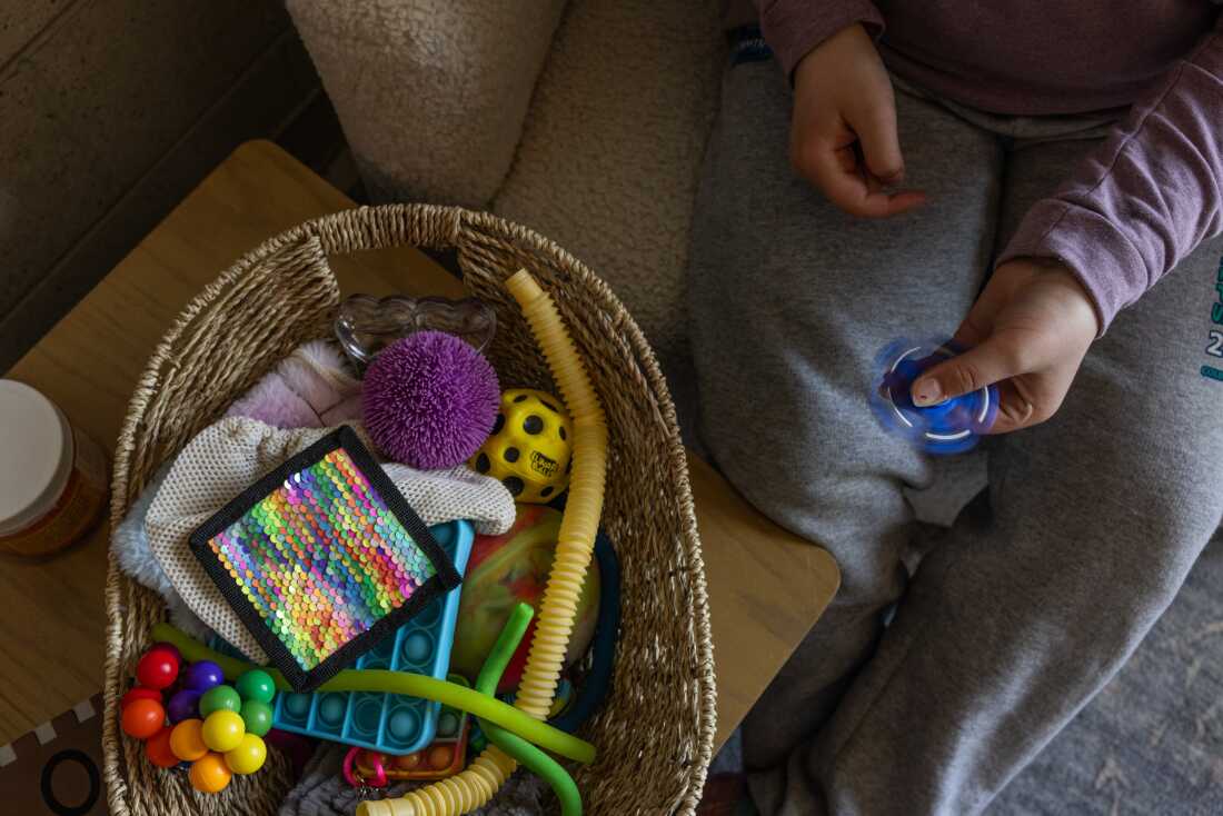A fifth-grader at Mill Stream plays with a fidget toy in her counselor Jordan Chighali’s office. 