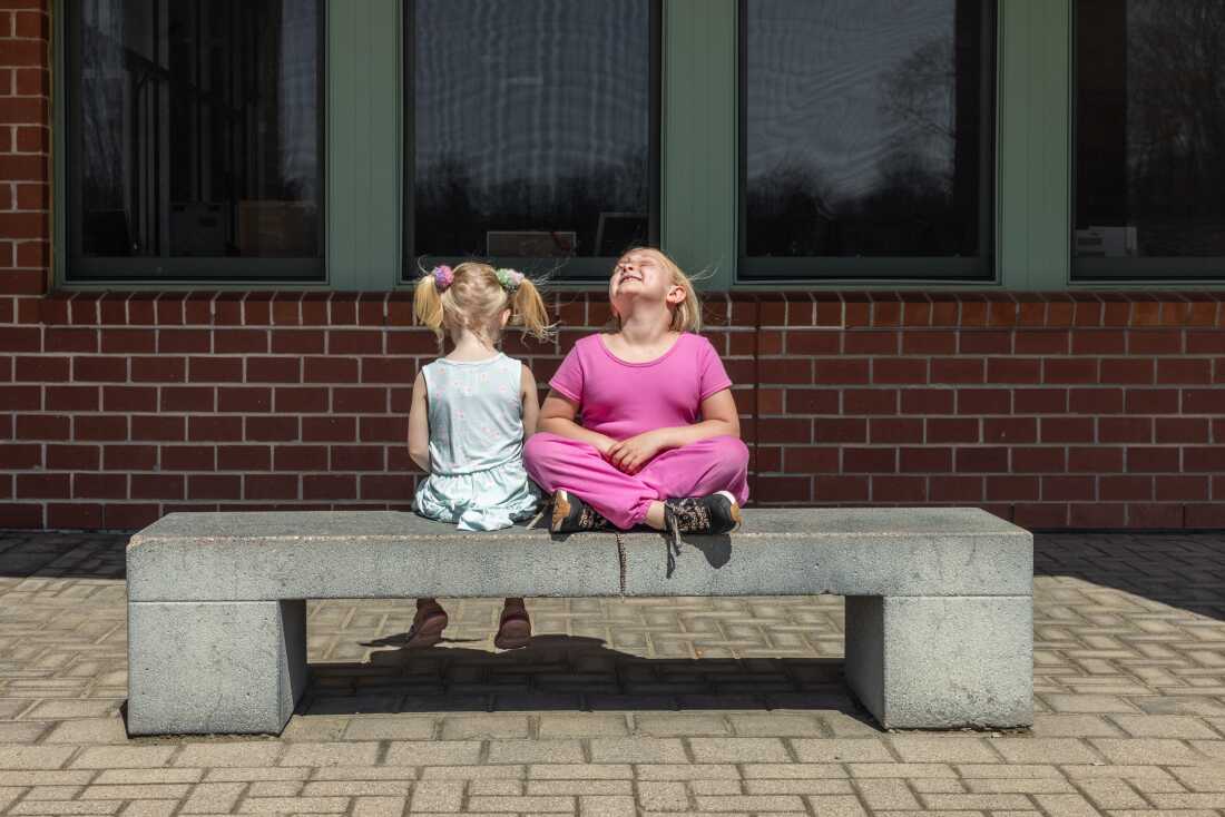 Second grader Mia Martin (right) shares a moment outside of school with younger sister Sophia Martin, who is not yet school age. 