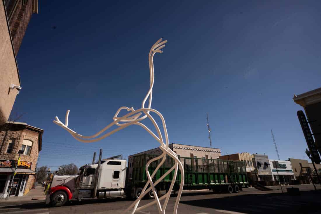 A metal sculpture of a graceful, dancing figure.