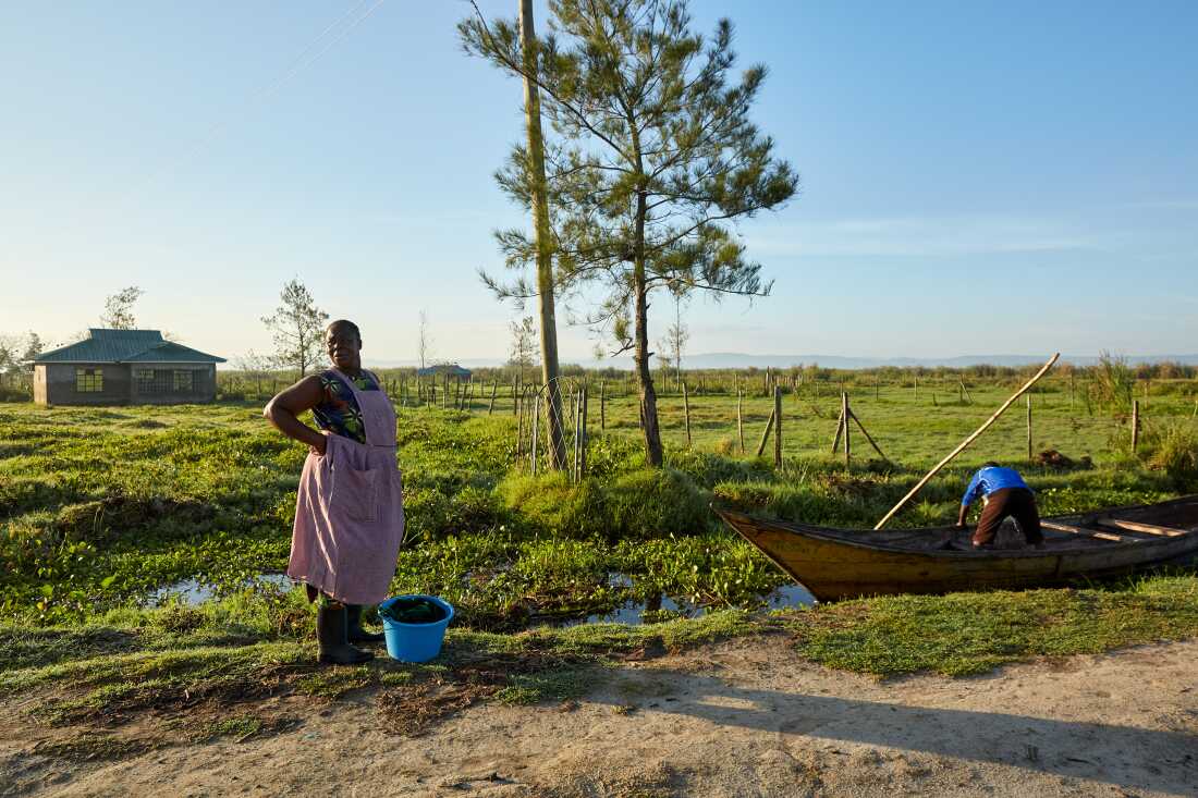 Alice Akinyi, a No Sex For Fish member, waits to take a boat to Nduru Beach, Kisumu, Kenya, 2025. The road isn't in good condition, especially after the floods of 2020, and makes it harder to access the beach.