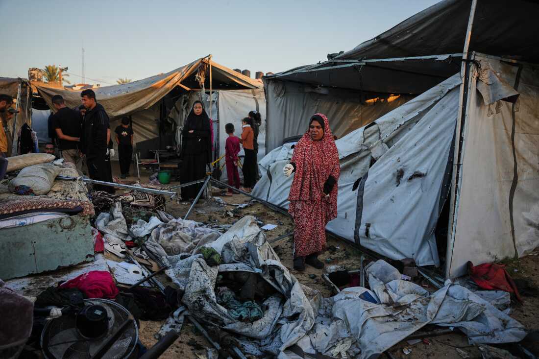 Displaced Palestinians inspect the damage after an Israeli army strike on their tent camp in Deir al-Balah, Gaza Strip, Wednesday.
