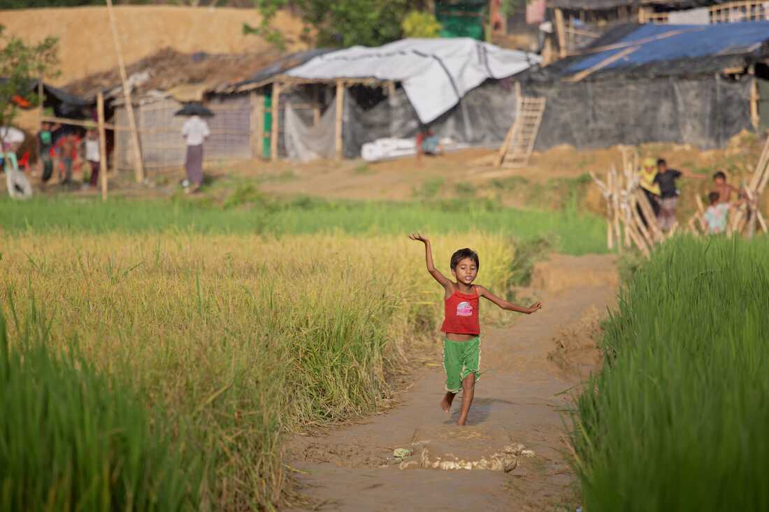 A child dances and sings while running through an IDP camp for Rohingya refugees outside of Cox's Bazar, Bangladesh on October 12, 2017.