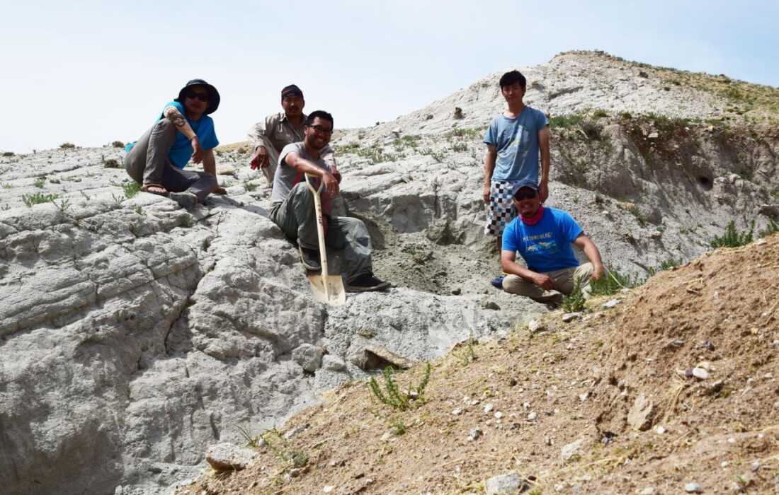 After excavating the new dinosaur in 2019, Chinzorig Tsogtbaatar (seated, far right) and other members of the expedition rest beside the quarry.