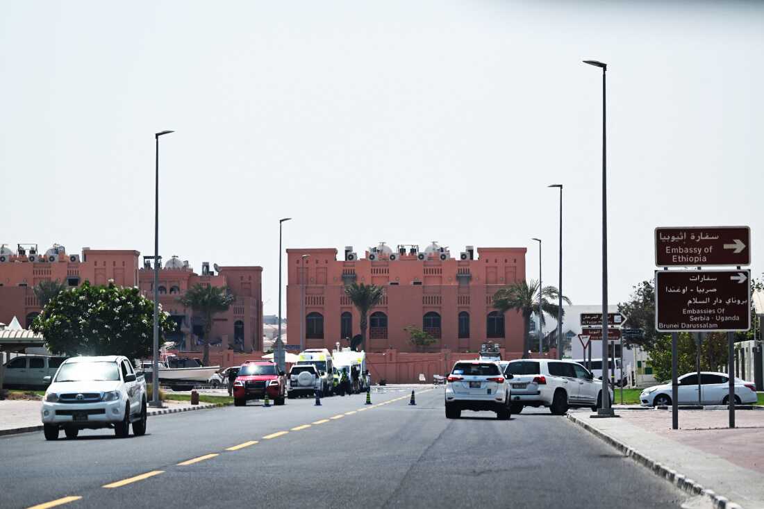 A picture taken from a distance shows the damaged building (L) in the compound housing members of Palestinian militant group Hamas's political bureau which was targeted the previous day by an Israeli strike in Qatar's capital Doha, on Sept. 10, 2025.