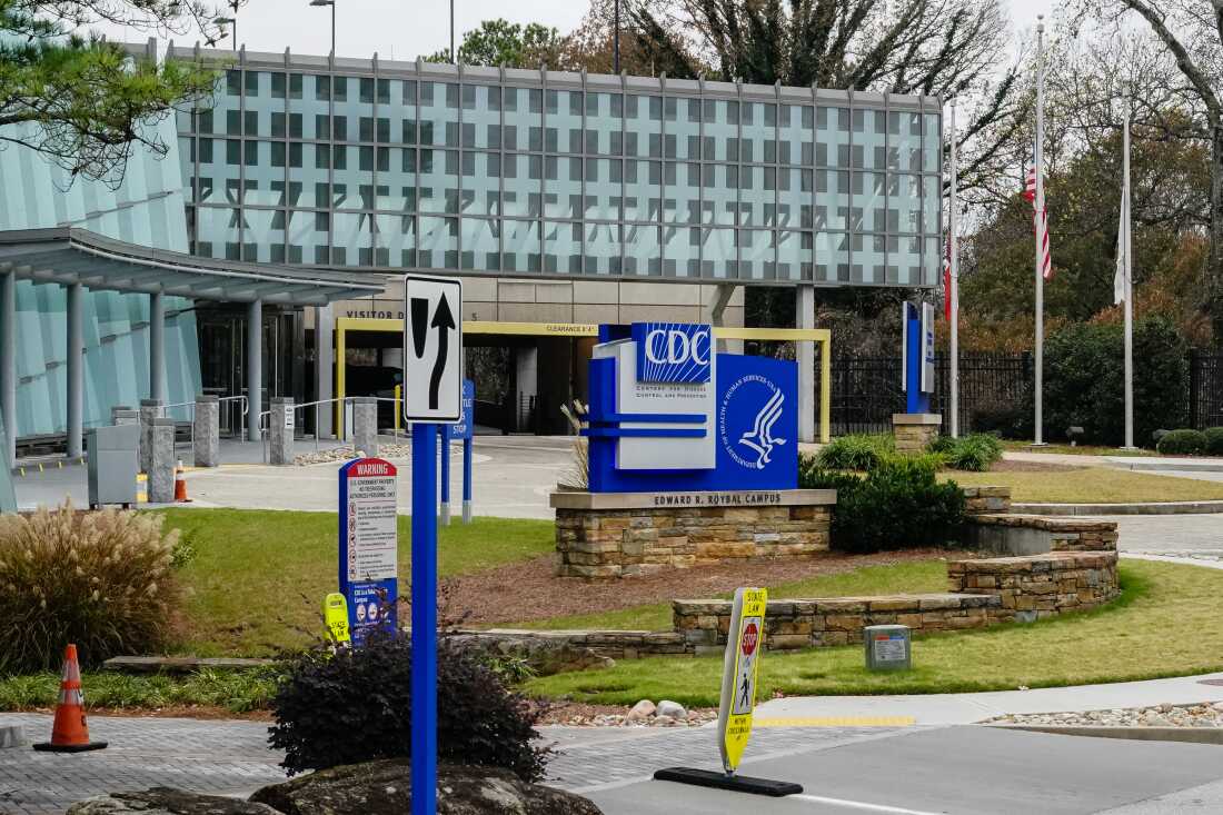A building of the Centers of Disease Control and Prevention in Atlanta, Georgia is shown. A sign with the CDC logo is in front of the building.