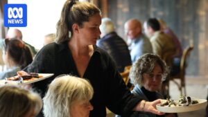 Sarah Bensen serving guests at Brickendon Estate's long-table Sunday lamb roast