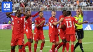 Breel Embolo consoled by teammates after being shown a red card against Argentina