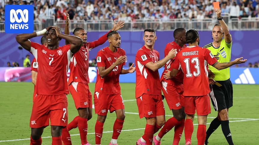 Breel Embolo consoled by teammates after being shown a red card against Argentina