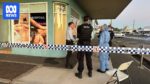 Police at a cordoned-off scene on Denham Street in Rockhampton's CBD with police tape