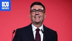 Andy Burnham smiling after confirmation as Labour leader at a podium
